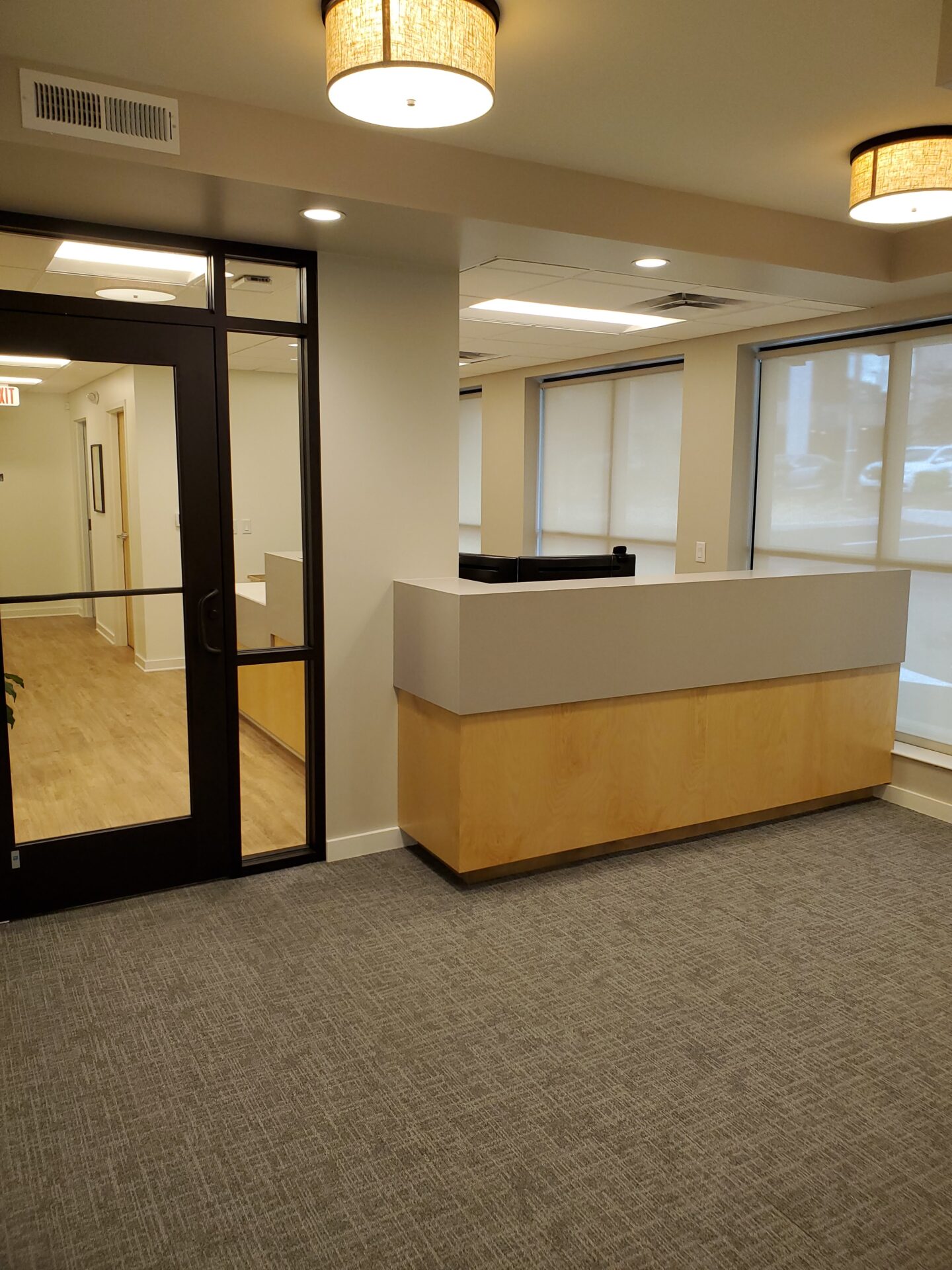 A Reception Area With Carpet in Cream Color